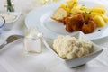 Few pieces of cauliflower in white bowl on lunch table Royalty Free Stock Photo