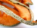 A few pieces of dried melon on a white background. dried melon Royalty Free Stock Photo