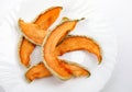 A few pieces of dried melon on a white plate. dried melon Royalty Free Stock Photo