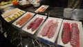 Few plates of raw fish on display table