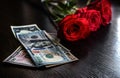 A few red roses and dollars are on the table Royalty Free Stock Photo