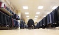 Few rows of jackets and men trousers in shop Royalty Free Stock Photo