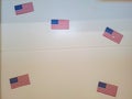 A few small American flags on the white door at school Royalty Free Stock Photo