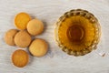 Few small biscuits, transparent cup with tea on table. Top view Royalty Free Stock Photo