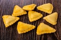 Few fried savory pies on wooden table