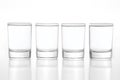 Few small shot glasses filled with alcohol on a light background Royalty Free Stock Photo