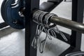 A few spring collars hanging on an olympic barbell at the gym