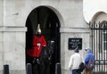 Few tourists standing and watching a mounted Royal Horse Guard on duty at Horseguards Parade