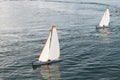 Few Toy Yacht Sail In Sea. Sailing Toy Boat On Sea Surface. Yachting And Sailing. Model Ship.