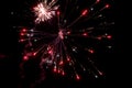 A few volleys of festive fireworks in the night sky, red-yellow. Royalty Free Stock Photo