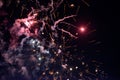 A few volleys of festive fireworks in the night sky, red-yellow. Royalty Free Stock Photo