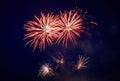 A few volleys of festive fireworks in the night sky, red-yellow Royalty Free Stock Photo