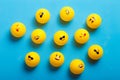 A few yellow balls with different emojis on a blue background