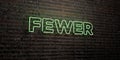 FEWER -Realistic Neon Sign on Brick Wall background - 3D rendered royalty free stock image