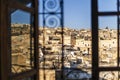 Fez medina seen through riad`s window with decorative grate, Morocco, Africa