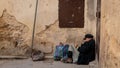 Anonymous poor beggar in the street of Fez, Morocco.