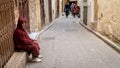 Anonymous poor beggar in the street of Fez, Morocco.