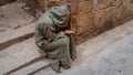 Anonymous poor beggar in the street of Fez, Morocco.