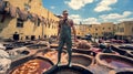 Man working as a tanner in the dye pots at leather tanneries at medina, Fez, Morocco. Royalty Free Stock Photo