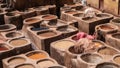 Man working as a tanner in the dye pots at leather tanneries at medina, Fez, Morocco. Royalty Free Stock Photo