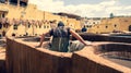 Man working as a tanner in the dye pots at leather tanneries at medina, Fez, Morocco. Royalty Free Stock Photo