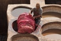 FEZ, MOROCCO - FEBRUARY 20, 2017: Man working within the paint holes at the famous Chouara Tannery in the medina of Fez. Royalty Free Stock Photo
