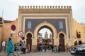 Fez, Morocco - grand city gate Bab Bou Jeloud in Fes el Bali. Monumental French entrance with pedestrians passing through.