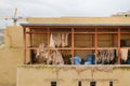 Fez, Morocco - male worker sorts out treated animal hides on a covered balcony at Chouara Tannery in Fes el Bali. 11th century