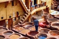 FEZ, MOROCCO - MAY 31, 2017: Unknown man gives orders to workers in the tannery in Fez. The tanning industry in the city is Royalty Free Stock Photo