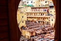 Fez, Morocco - November 12, 2019: Dye reservoirs and vats in traditional tannery of city. With selective focus Royalty Free Stock Photo