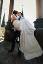 Fiance holds bride in his arms on the rooftop of old cathedral Royalty Free Stock Photo