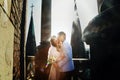 Fiance kisses a bride in chick in the rays of sunlight in front