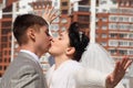 Fiance kisses bride outdoor Royalty Free Stock Photo