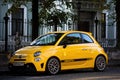 Fiat 500 Abarth parked in the street. Yellow small popular city car Royalty Free Stock Photo