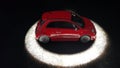 Fiat 500 car vintage red toy standing in light circle Royalty Free Stock Photo