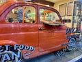 Fiat Cinquecento sits in front window of Arancina Pizza, Portobello Road, London