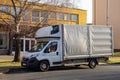 Fiat Ducato flatbed light commercial vehicle parked at sunset on a street ready to transport some goods