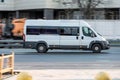 Fiat Ducato white shuttle bus van driving on the street, side view