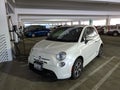 The Fiat 500e Electric Vehicle is charging at the station