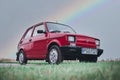 Fiat 126p, also known as `Maluch`, iconic small Polish car with a rainbow background Royalty Free Stock Photo