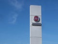 Fiat Professional logo in the dealership of the area, against blue sky. It is the brand name for Fiat group commercial vehicles