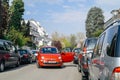 Fiat 500 red car with open door blocking entire street