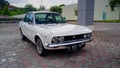 Fiat 124 Sport coupe parked in a car parking lot