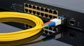 Fiber optic cable connected to network switch for high-speed data transfer Royalty Free Stock Photo