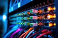 Fiber Optic cables connected to an optic ports in data center, close up of network cables connected to an internet hub, shallow Royalty Free Stock Photo