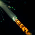 Fiber optic cables emitting light in a dark setting. The cable core is surrounded by Royalty Free Stock Photo