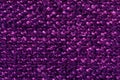 fiber texture polyester close-up. violet fleecy background. shaggy surface. fine grain felt red fabric