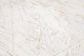 Fiberboard plywood roughly painted with white paint, texture background, glued wood chips Royalty Free Stock Photo