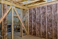 Insulation in the sloping attic of a new frame house Royalty Free Stock Photo