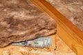 Fiberglass insulation with cash money in attic of house. Royalty Free Stock Photo